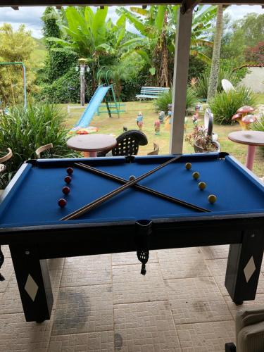 a pool table with balls on it in a yard at Pousada Recanto dos Arcos in Conservatória