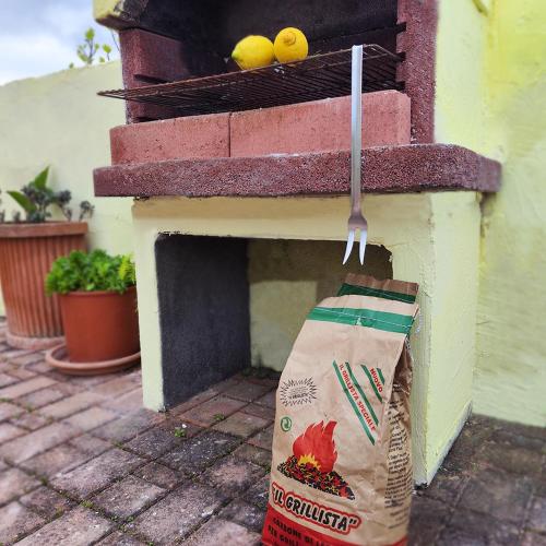 a bag of groceries is hanging from an outdoor oven at Villa Genesia in Bacoli