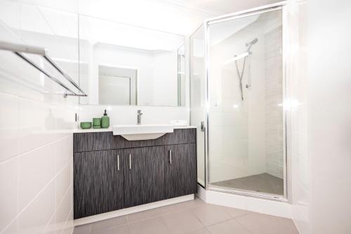 a bathroom with a sink and a shower at Urban Retreat Townhouse near CBD in Perth