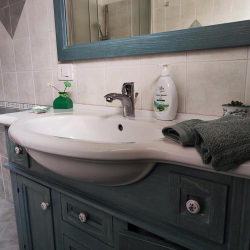 a bathroom with a sink and a mirror at Villa Genesia in Bacoli