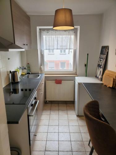 a kitchen with a sink and a window in it at Monteurwohnung Heilbronn nahe Neckarsulm in Heilbronn