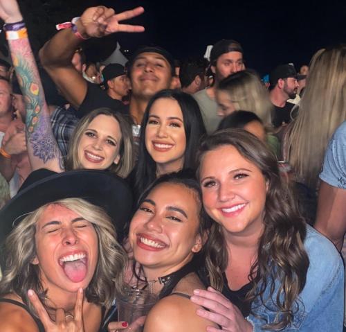 a group of women in a crowd at a concert at Gaslamp Hostel in San Diego