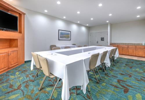 a conference room with a large white table and chairs at Candlewood Suites Fort Worth West by IHG in Fort Worth