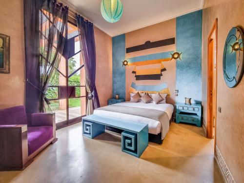 Villa Soraya/Noor Hotel & Spa في مراكش: غرفة نوم بسرير كبير وكرسي أرجواني