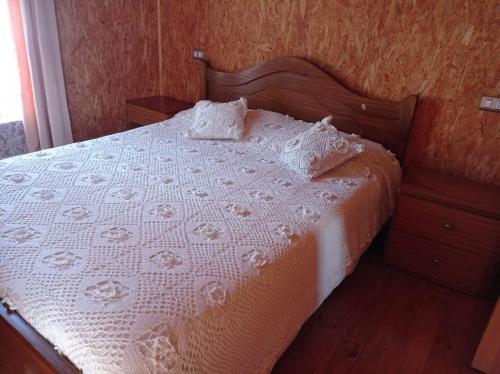 a bed with a white bedspread and pillows on it at Departamento Erica 2 in Panguipulli
