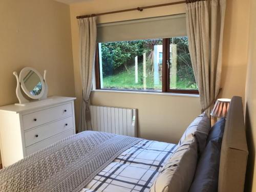 a bedroom with a bed and a window at Westport Retreat Apartment in Westport