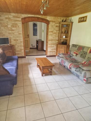 a living room with a couch and a coffee table at Week-end séjour à la campagne in Cornimont