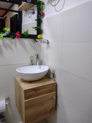 a bathroom with a white sink and a mirror at Natural Getaway in Bogotá