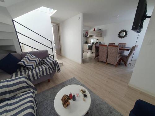 a living room with a couch and a table at Casa El Rincón del Sol in Quito