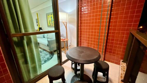 mesa pequeña y sillas en una habitación con espejo en Edf Duetto 2 QTS c/ar, en Maceió