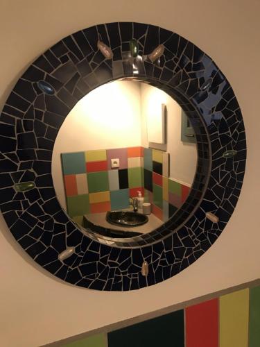 a mirror in a bathroom with a sink at BelCiano (ancien Toit Vert) in Fitou