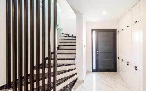 a staircase in a house with a door and a hallway at Royal Villas in Kérynia