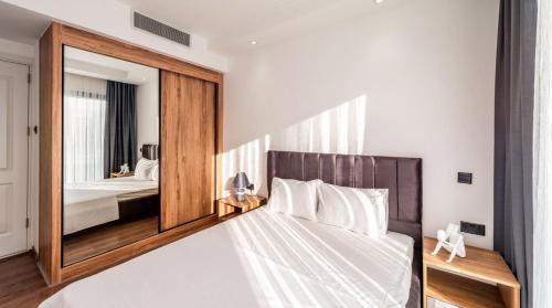 a bedroom with a bed with a large mirror at Royal Villas in Kérynia