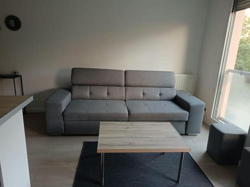 a living room with a couch and a coffee table at PARIS La Défense Appt 3 Pièces in Nanterre