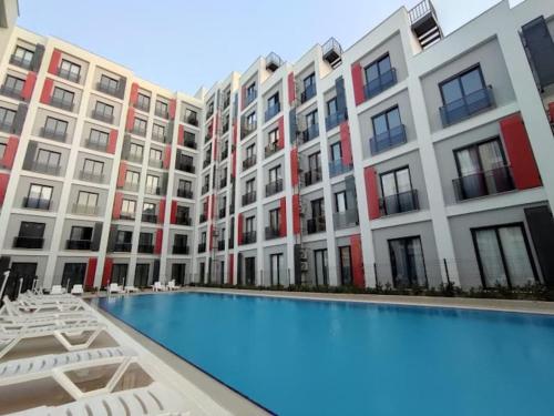 a large apartment building with a large swimming pool at Comfort and Peace in a Luxury Residence! in Antalya
