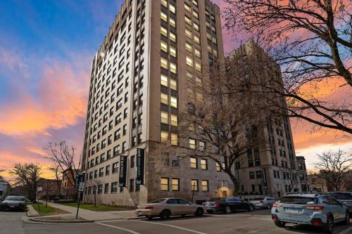 a tall building with cars parked in front of it at Inviting 2-Bedroom Apt in Hyde Park - The Blackwood rep in Chicago
