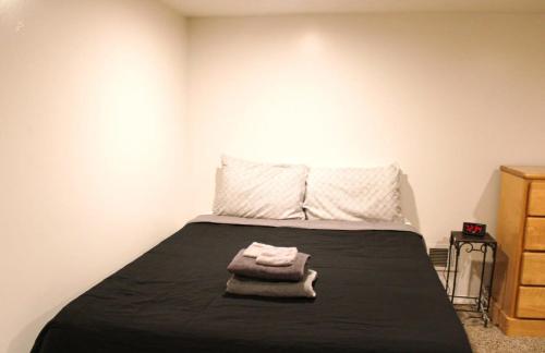 a bedroom with a bed with a black blanket at 1 Bed Apt - Amazing Location 1 Block to Carson St in Pittsburgh