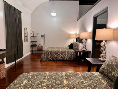 a hotel room with two beds and a table at The Mercantile on the Katy Trail in Hermann