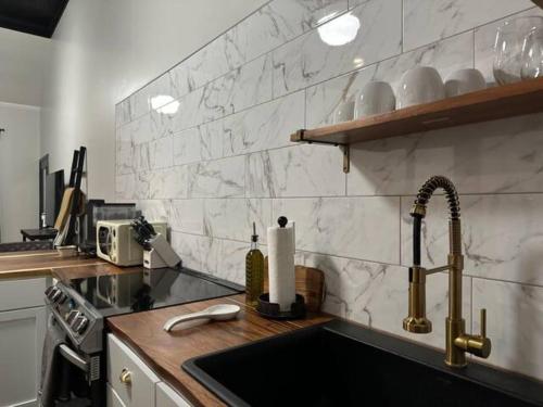 a kitchen with a sink and a counter top at The Mercantile on the Katy Trail in Hermann