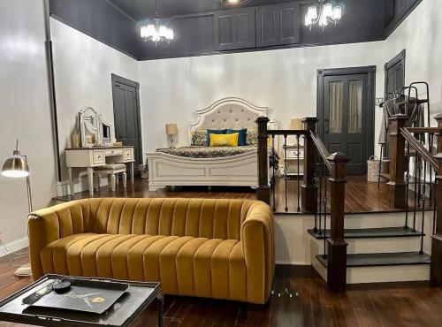 a living room with a couch and a bed at The Mercantile on the Katy Trail in Hermann