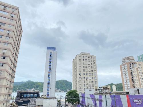 a group of tall buildings in a city at Pé na Areia Praia do Gonzaguinha in São Vicente