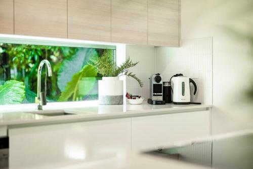 a kitchen counter with a sink and a window at Serene 2BR Beachfront Getaway on the Esplanade in Clifton Beach