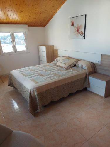 A bed or beds in a room at Casa Fraga