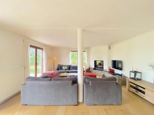 a living room with two couches and a table at Vakantiehuis Wilogne in Dinez