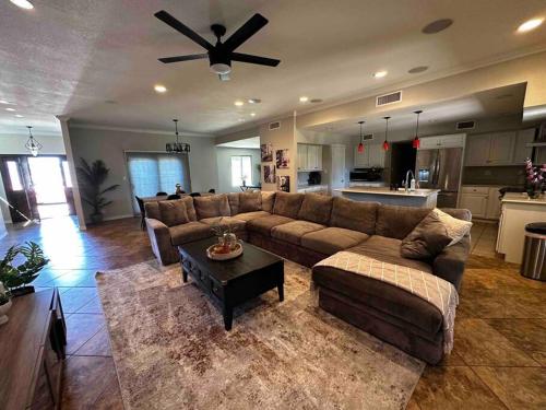 a living room with a couch and a ceiling fan at Scottsdale Luxury Retreat in Scottsdale