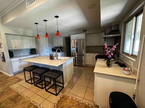 a kitchen with a counter and a island in a room at Scottsdale Luxury Retreat in Scottsdale