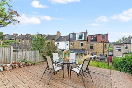 a patio with a table and chairs on a wooden deck at Room with a view Catford, homestay in Hither Green