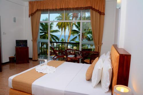 a bedroom with a bed with a view of the ocean at Sole Luna Resort & Spa in Tangalle