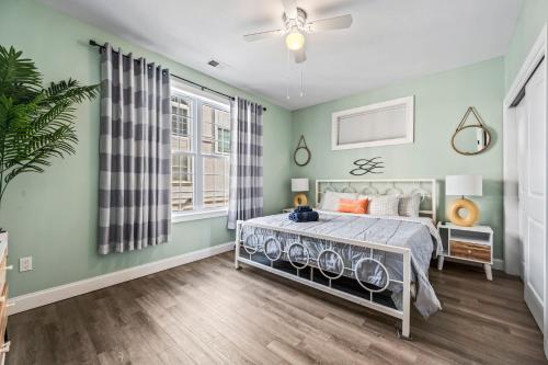 a bedroom with green walls and a bed at Beach House Steps away from the Boardwalk and Beach with Ocean Views in Seaside Heights! in Seaside Heights