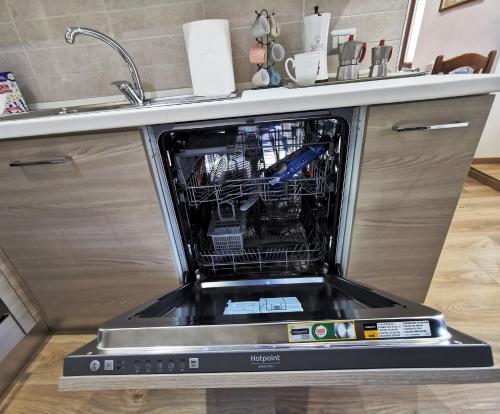 a dishwasher with its door open in a kitchen at LA TORRETTA apartment suite in Anagni