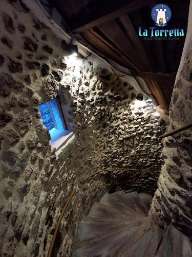 a stone tunnel with a sign that reads la tortilla at LA TORRETTA apartment suite in Anagni