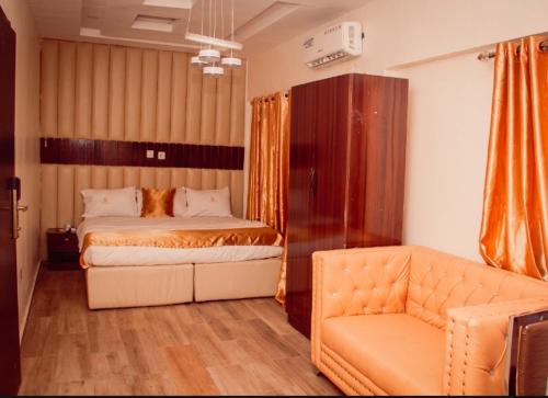 a bedroom with two beds and a couch in it at HOTEL D RITZ in Aba Adi