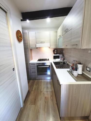 a kitchen with white cabinets and a stove top oven at LA TORRETTA apartment suite in Anagni