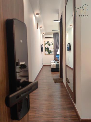 a hallway with a flat screen tv on a wall at K Avenue Modern Style Studio (5 Mins to Airport) in Kota Kinabalu