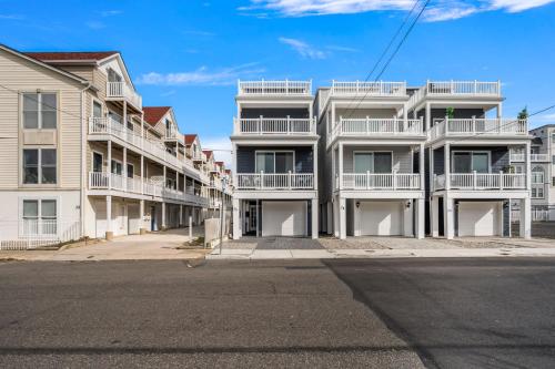 a row of apartment buildings on a street at Beach House Steps away from the Boardwalk and Beach with Ocean Views in Seaside Heights! in Seaside Heights