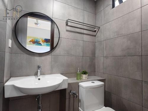 a bathroom with a sink and a toilet and a mirror at K Avenue Modern Style Studio (5 Mins to Airport) in Kota Kinabalu