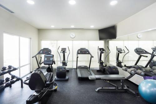 a gym with several tread machines in a room at Fairfield by Marriott Los Cabos in Cabo San Lucas