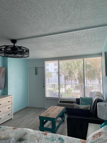 a living room with a couch and a table at Ocean Views Retreat Enjoy the Ocean View from your balcony in Daytona Beach