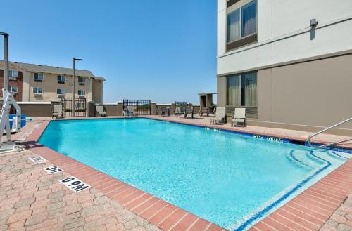 a large swimming pool on a apartment building at Holiday Inn Express Hotel & Suites Dallas Fort Worth Airport South by IHG in Irving