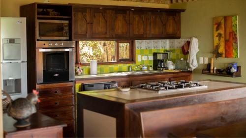 a kitchen with wooden cabinets and a stove top oven at Casas La Primavera in Villa de Leyva