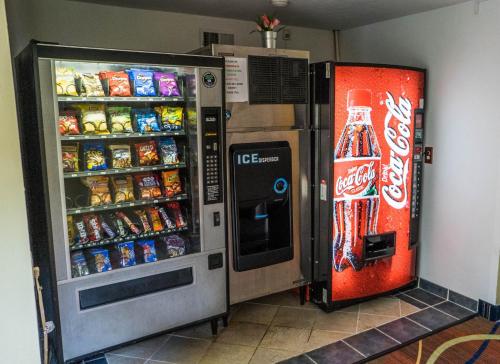 a cocacola soda machine and a coke refrigerator at The Mariner Resort Cape Cod by The Red Collection in West Yarmouth
