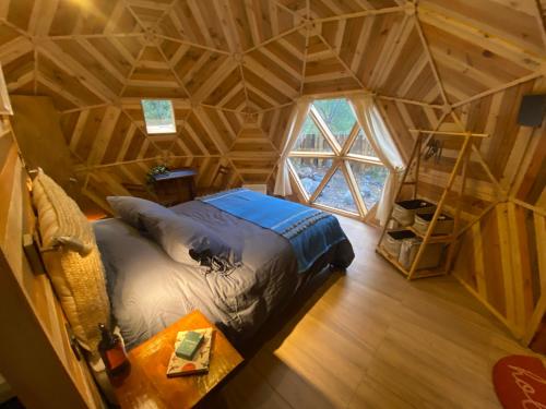 an overhead view of a bedroom in a tree house at Lodge Domos Awen in Pucón