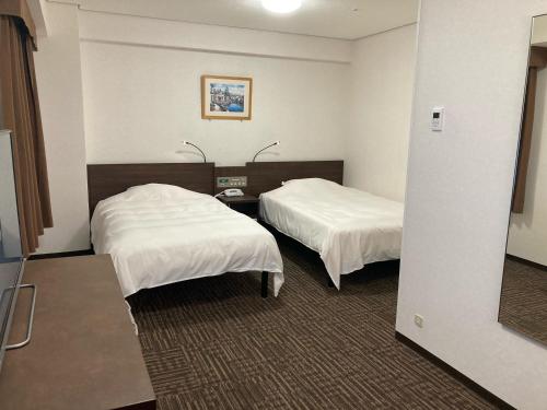 Postel nebo postele na pokoji v ubytování Hotel Alpha-One Tsuyama