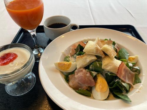a plate of food with a salad and a drink at Hotel Alpha-One Tsuyama in Tuyama