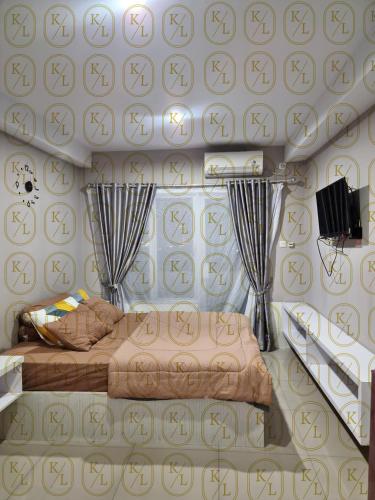 a room with two beds and a wall with symbols on it at SkyView Apartment By Kayu Lawang in Sunggal