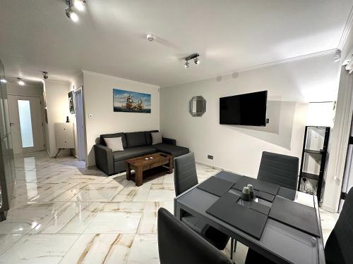 a living room with a couch and a table at Central London Zone 1 apartment in London
